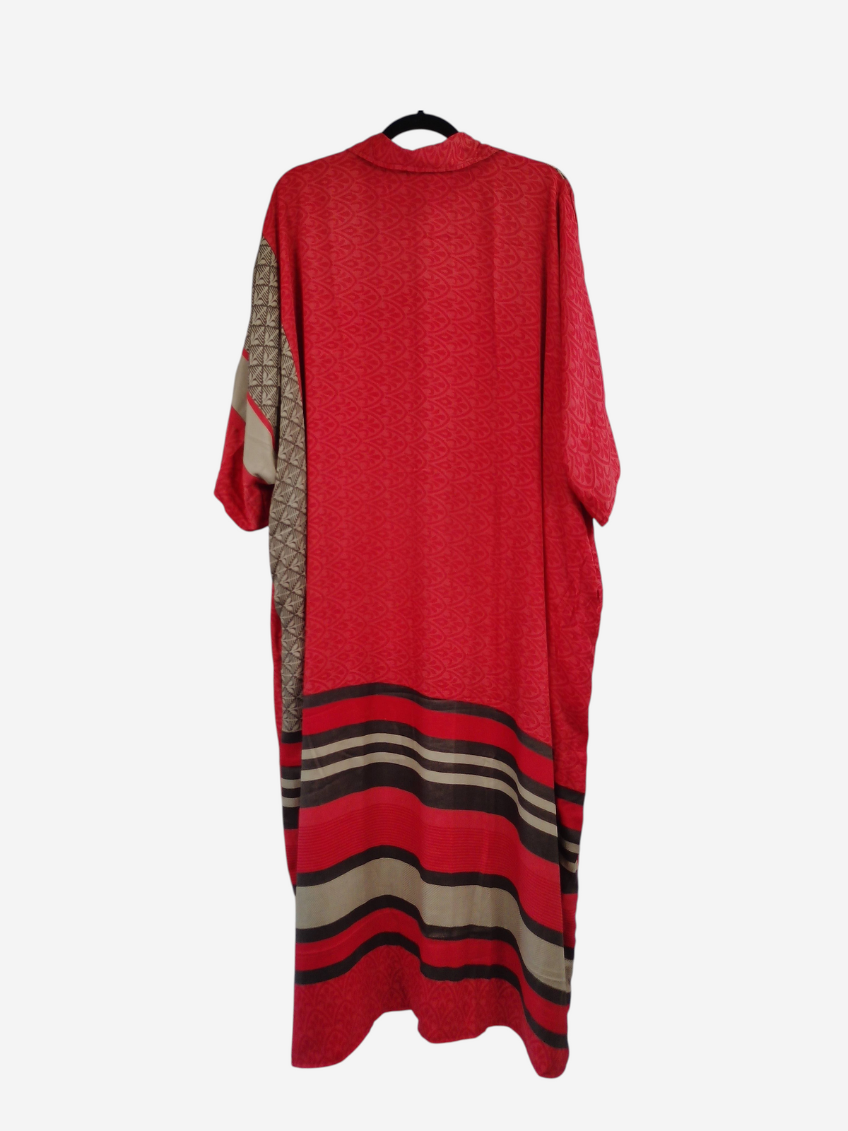She Lives Beauty reversible kaftan in red vintage rasgulla silk with striped and patterned panels on a hanger