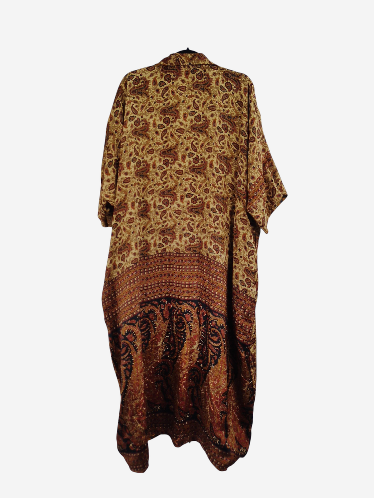She Lives Beauty reversible kaftan in vintage rasgulla silk with a brown and gold paisley print on a hanger.