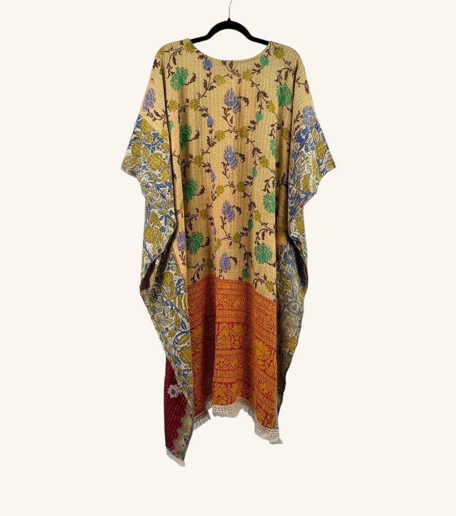 She Lives Beauty reversible Kantha top in vintage cotton with floral patterns, hi-low hem, and fringe detailing.