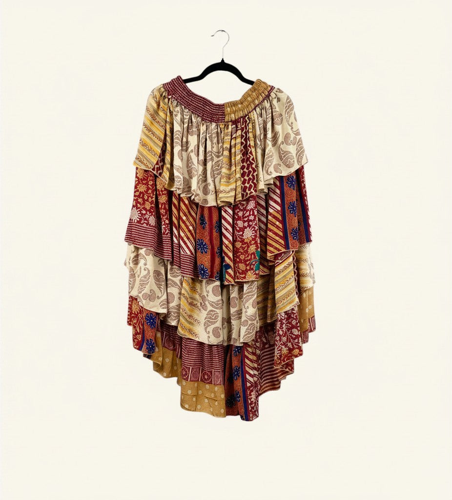 She Lives Beauty Ruffle Muse hi-lo skirt in vintage rasgulla silk with vibrant patchwork patterns and cascading ruffles.