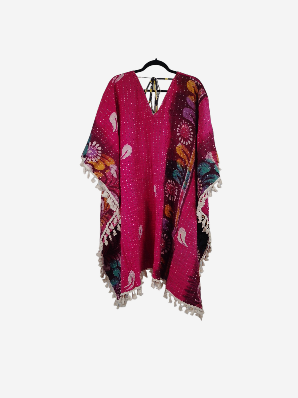 She Lives Beauty reversible pink vintage cotton kantha kimono with fringe trim and floral patterns on a hanger