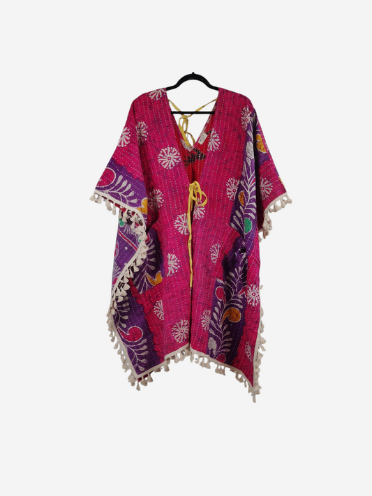 She Lives Beauty reversible pink kantha kimono with floral patterns, long sleeves, and cream fringe trim.