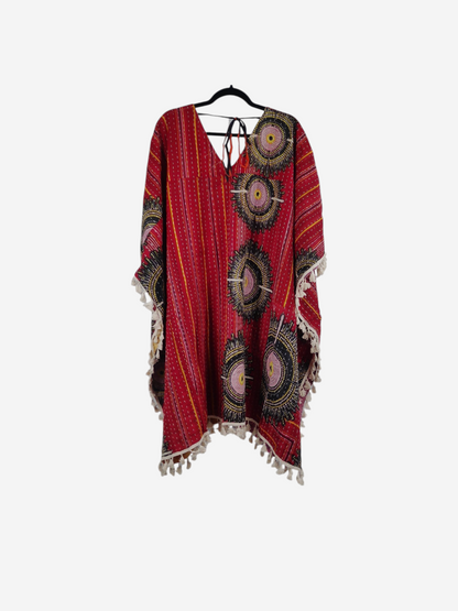 She Lives Beauty reversible red vintage cotton kantha kimono with circular patterns and fringe trim on a hanger.