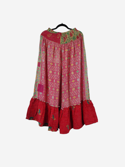She Lives Beauty Anything for Selenas pants in pink and red vintage kantha cotton with a ruffled hem on a hanger.