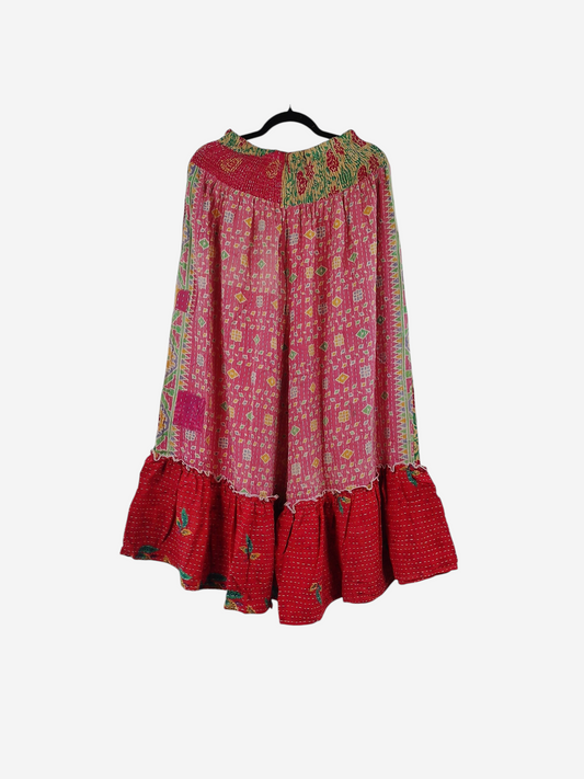 She Lives Beauty Anything for Selenas pants in pink and red vintage kantha cotton with a ruffled hem on a hanger.