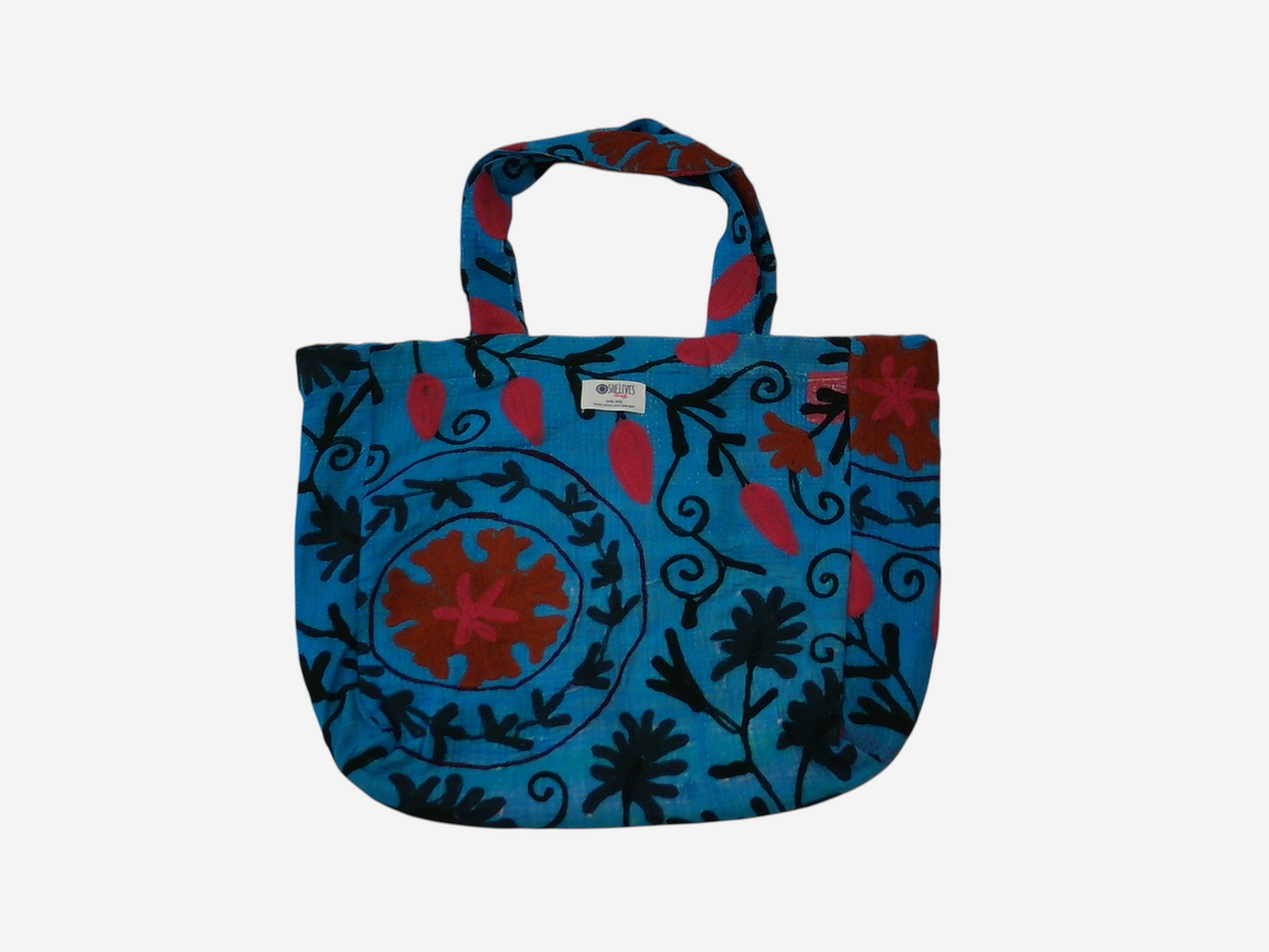 She Lives Beauty vintage Kantha and Suzani cotton tote bag featuring blue patchwork with red and black floral patterns