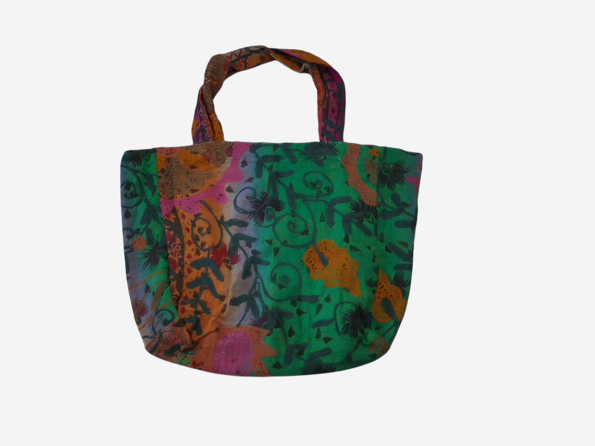 She Lives Beauty vintage Kantha and Suzani patchwork tote bag in vibrant green, orange, and purple cotton textiles.