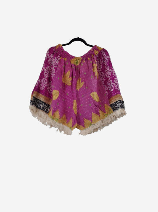 She Lives Beauty Alma Kantha fringe shorts in vibrant pink vintage cotton with yellow leaf patterns and boho trim.
