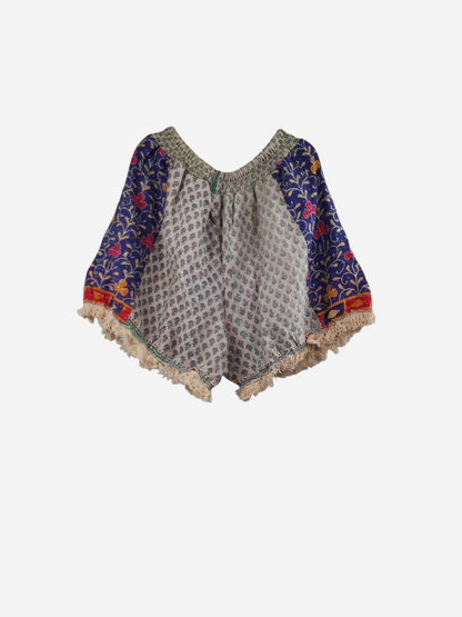 She Lives Beauty Alma Kantha fringe shorts in vintage cotton with blue and floral patterns on a white background.