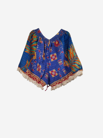 She Lives Beauty Alma Kantha fringe shorts in blue vintage cotton with floral patterns and cream-colored fringe trim.