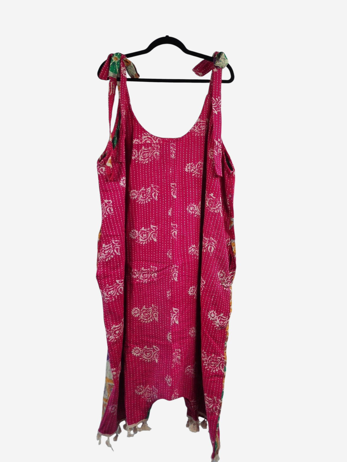 She Lives Beauty pink vintage cotton kantha jumpsuit with harem capri silhouette and tie straps on a hanger