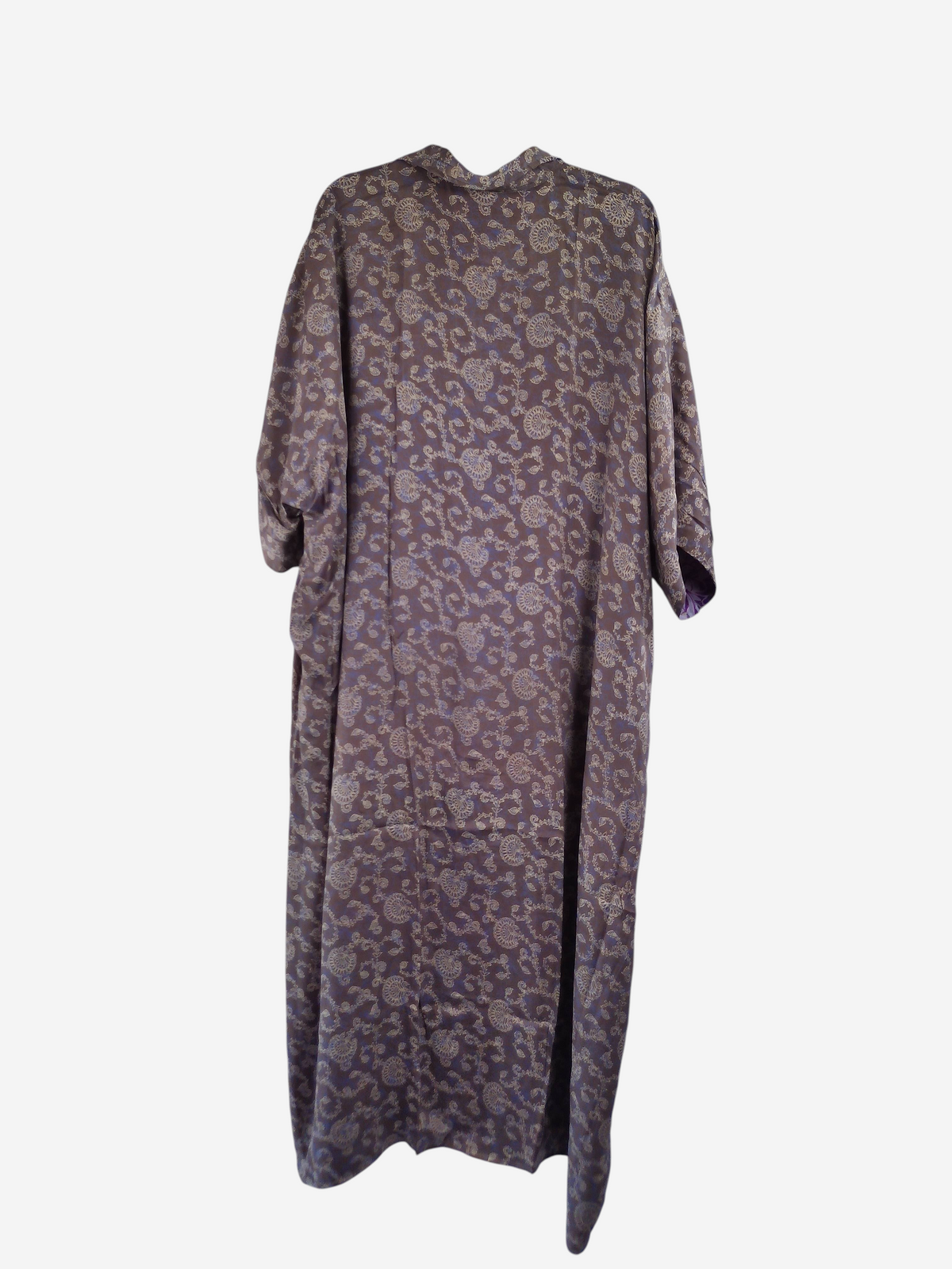 She Lives Beauty reversible kaftan in vintage rasgulla silk with a purple and cream floral pattern on a hanger