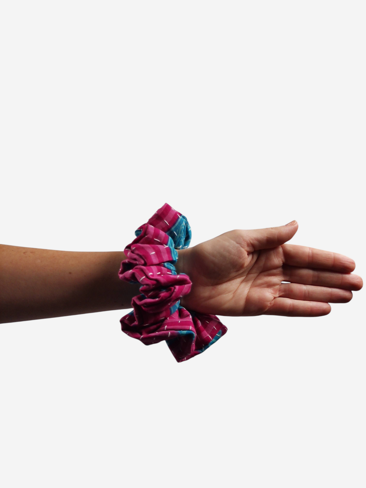 She Lives Beauty large kantha scrunchie made from vintage pink and blue cotton sari fabric worn on a woman's wrist