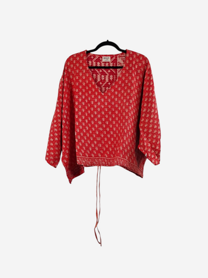 She Lives Beauty red vintage cotton kantha butterfly top with white paisley print and v-neckline on a hanger.