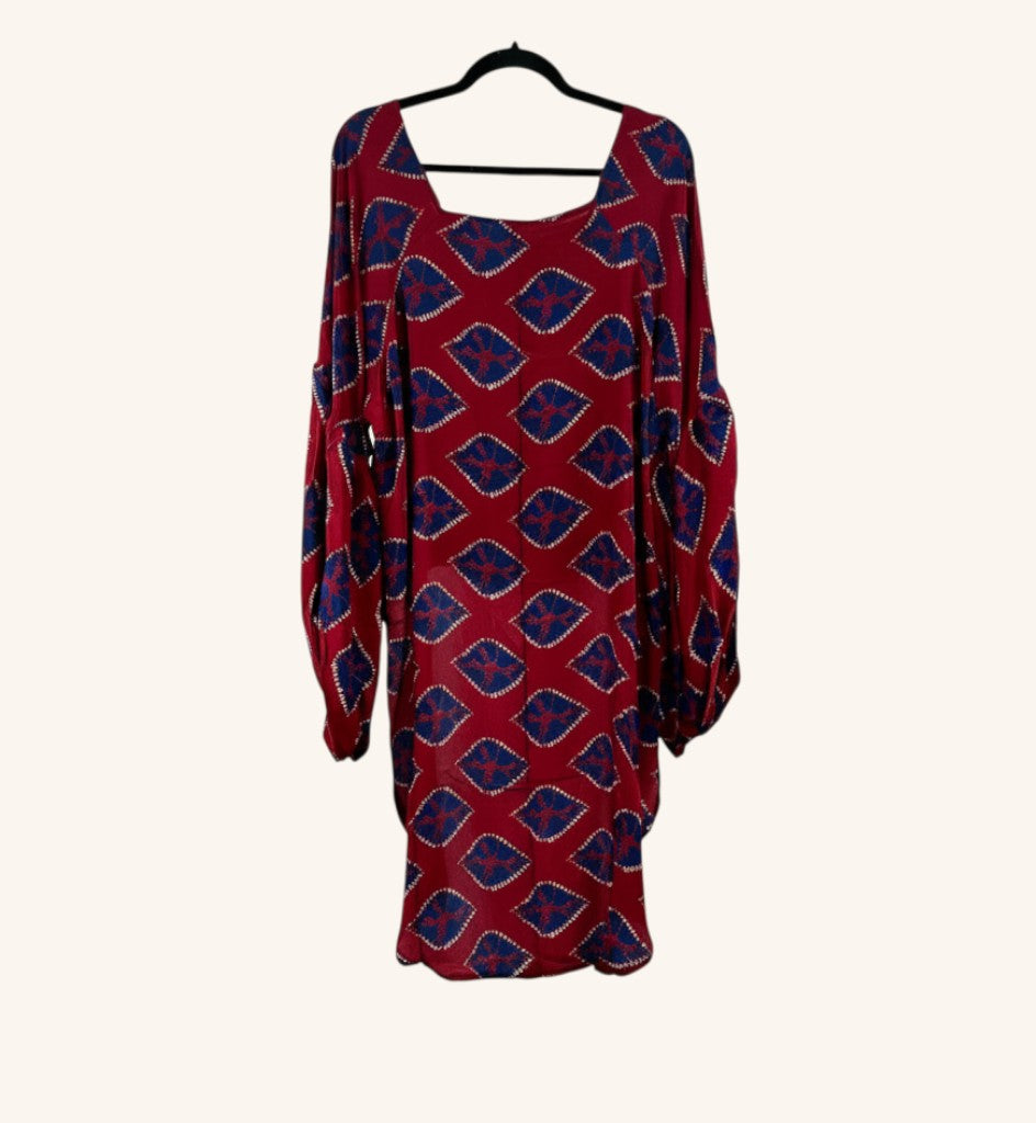 She Lives Beauty Desert Rain silk top in red and blue with a geometric print, ruffle sleeves, and hi-low hem.