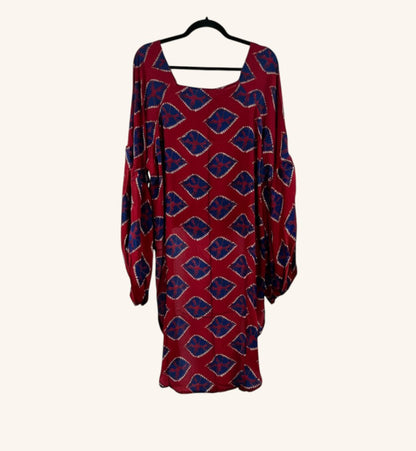 She Lives Beauty Desert Rain silk top in red and blue with a geometric print, ruffle sleeves, and hi-low hem.