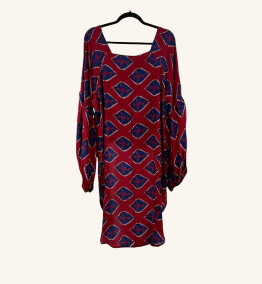 She Lives Beauty Desert Rain silk top in red and blue with a geometric print, ruffle sleeves, and hi-low hem.