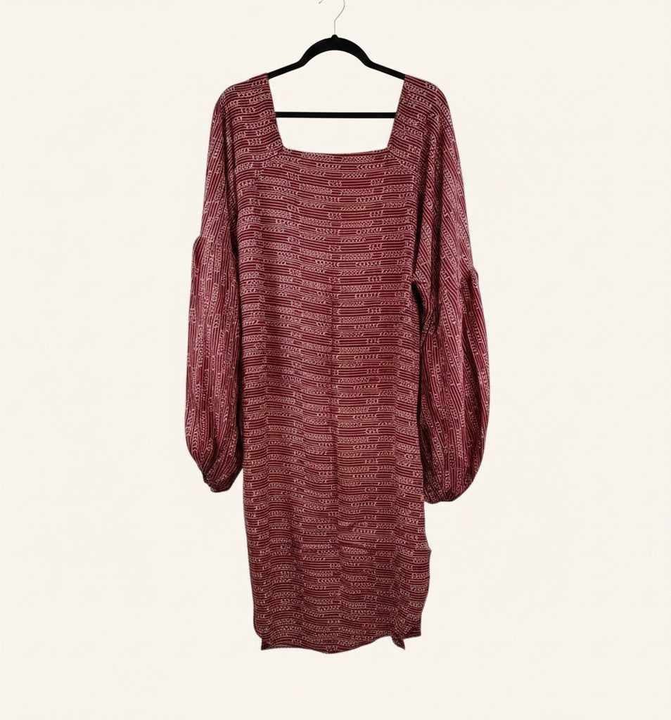 She Lives Beauty Desert Rain silk top in deep red with white geometric patterns, square neckline, and puff sleeves.