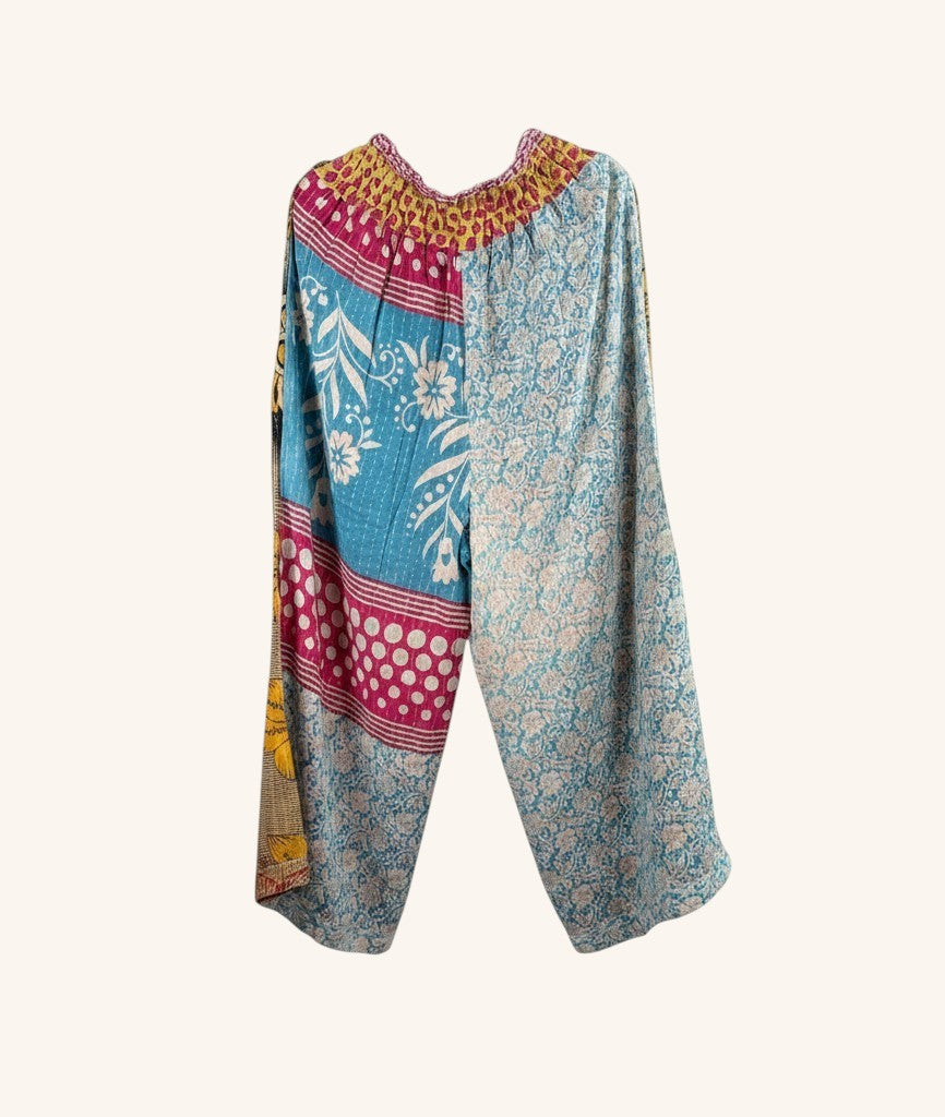 She Lives Beauty wide-leg pants made from vintage kantha cotton saris with patchwork blue and floral patterns.