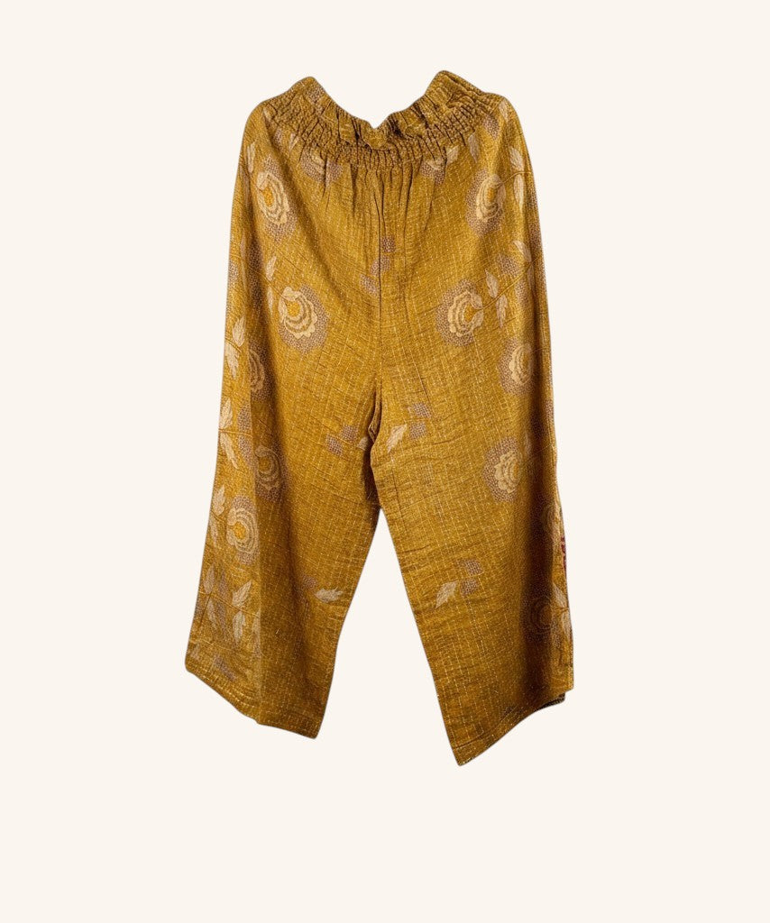 She Lives Beauty mustard yellow wide leg pants made from vintage kantha stitched cotton with floral patterns.