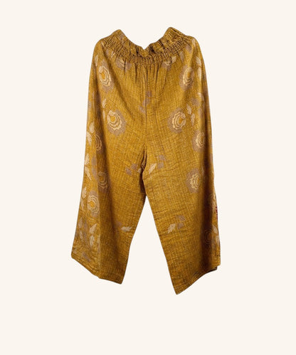 She Lives Beauty mustard yellow wide leg pants made from vintage kantha stitched cotton with floral patterns.