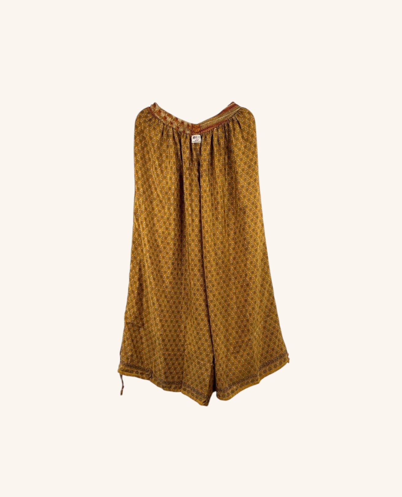 She Lives Beauty wide leg nomad pants in mustard yellow vintage rasgulla silk with intricate geometric patterns.