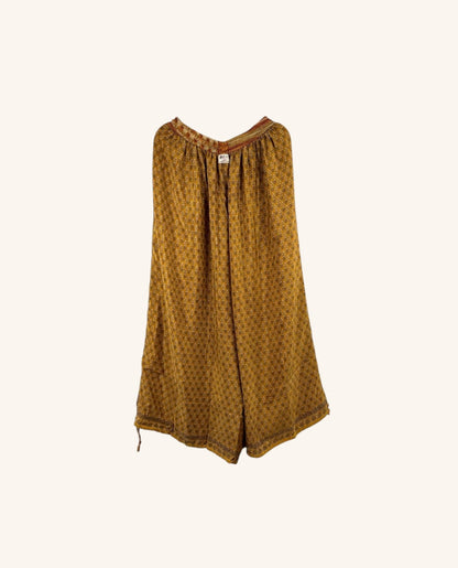 She Lives Beauty wide leg nomad pants in mustard yellow vintage rasgulla silk with intricate geometric patterns.