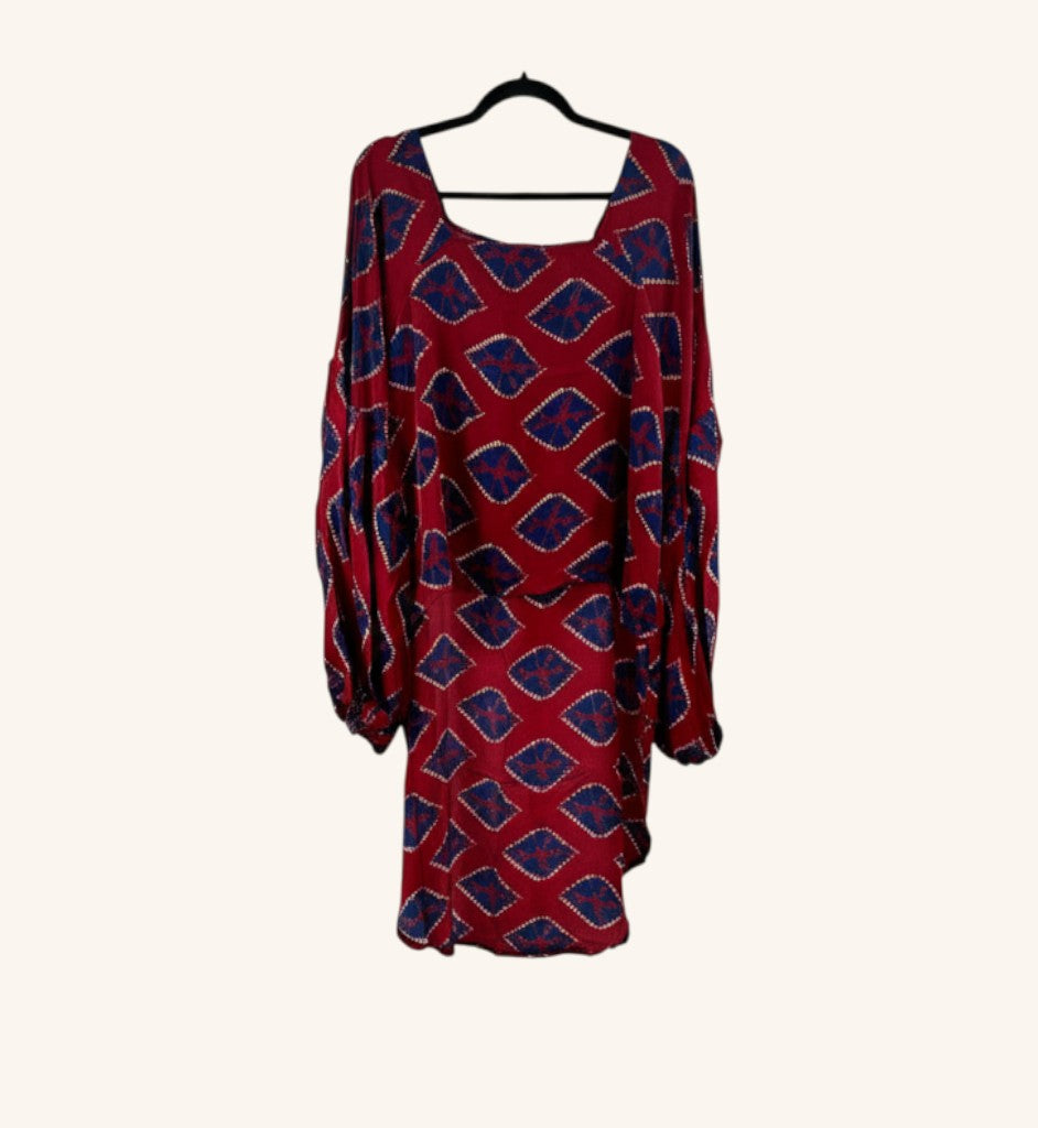 She Lives Beauty Desert Rain silk top in red with blue diamond patterns, featuring oversized sleeves and hi-low hem.