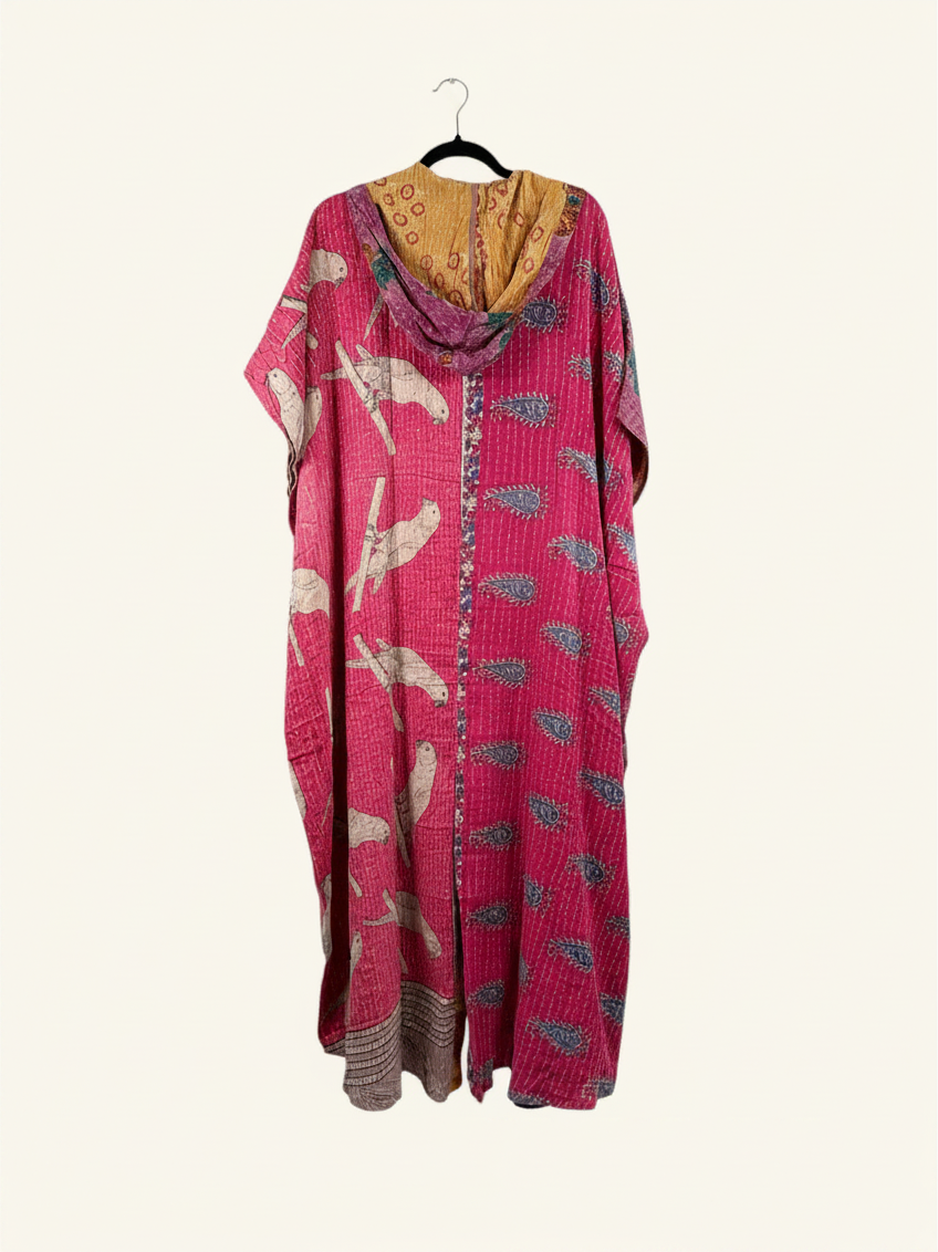 She Lives Beauty reversible dahlia jumpsuit in pink vintage kantha cotton with bird and paisley patterns on a hanger