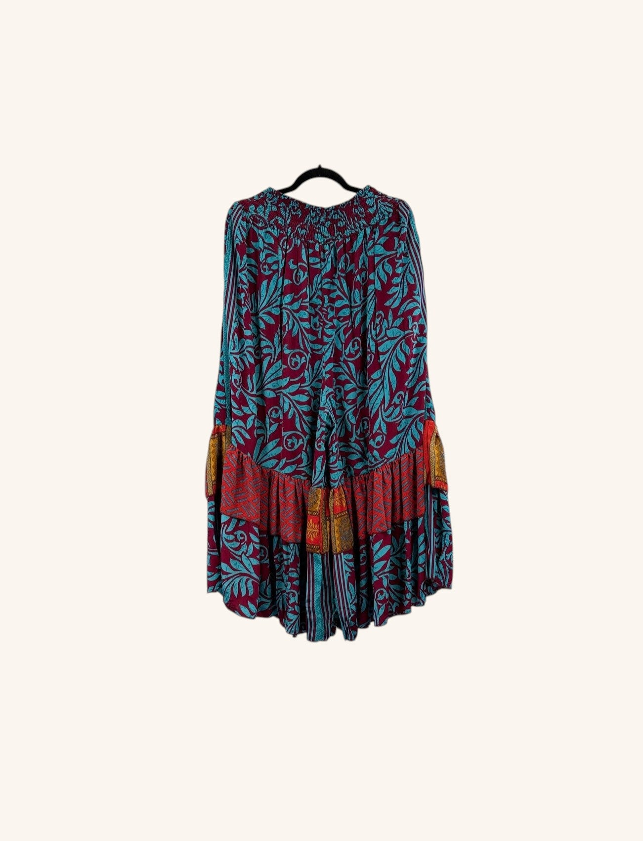 She Lives Beauty Gypsy Moon silk ruffle pants in a bohemian floral print with deep red and teal tones.