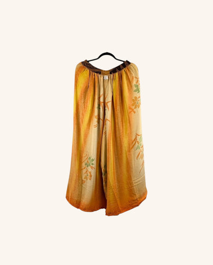 She Lives Beauty wide leg pants in yellow and orange vintage rasgulla silk with floral patterns and a dark waistband.