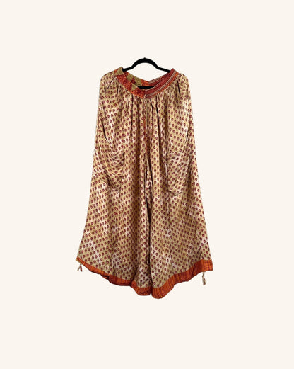 She Lives Beauty vintage silk wide-leg jogger pants in a cream and red floral print with an orange waistband.