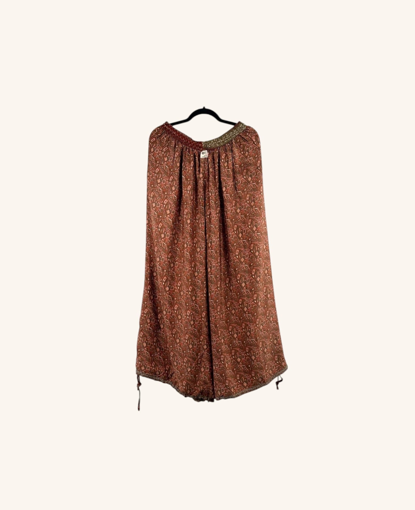 She Lives Beauty vintage Rasgulla silk wide-leg pants in a rust-toned patchwork print with a relaxed silhouette.