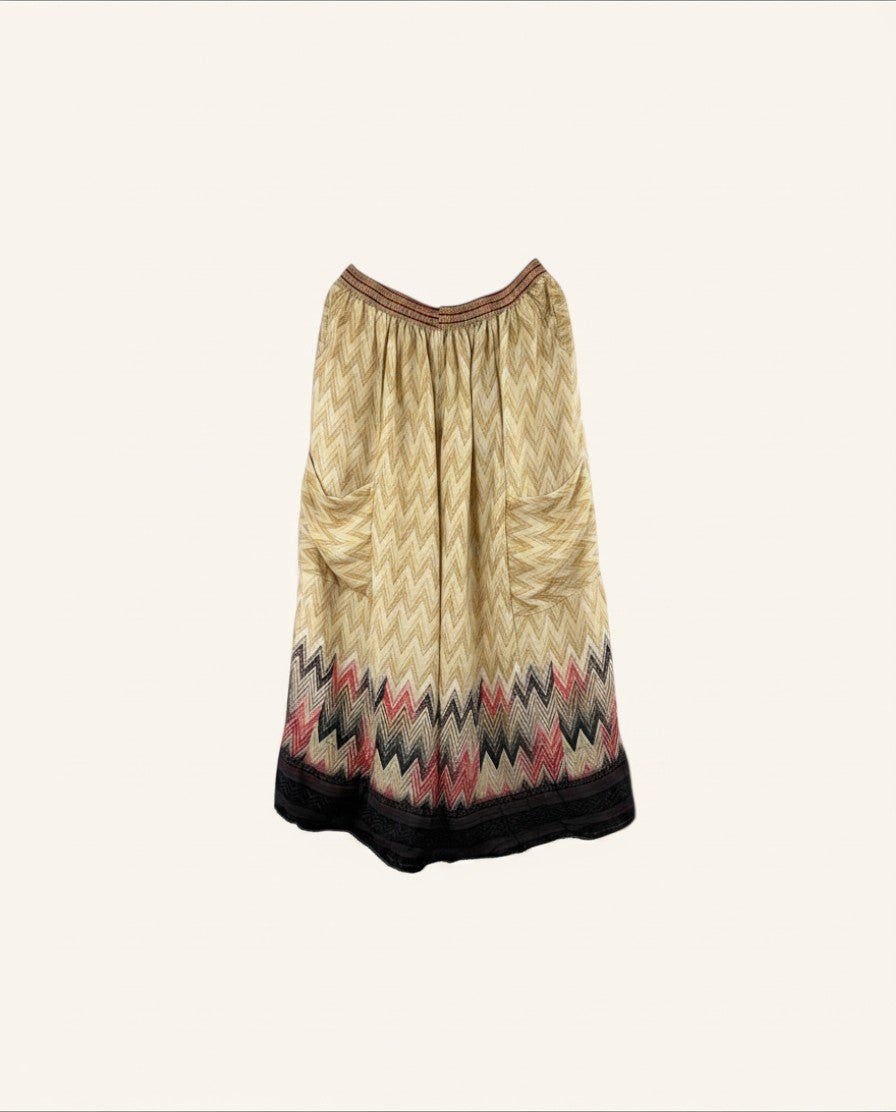 She Lives Beauty vintage silk wide leg pants featuring a beige chevron pattern with red and black hem details.
