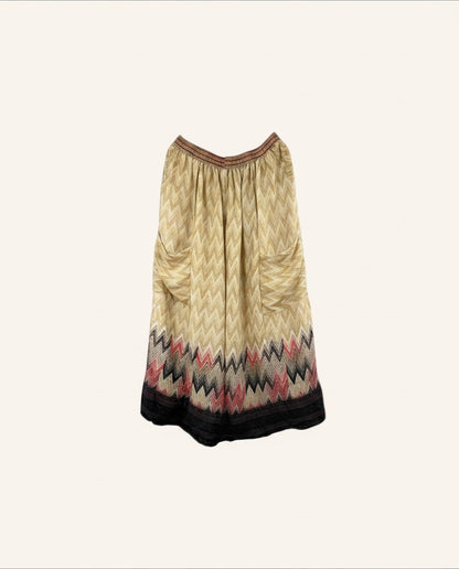 She Lives Beauty vintage silk wide leg pants featuring a beige chevron pattern with red and black hem details.
