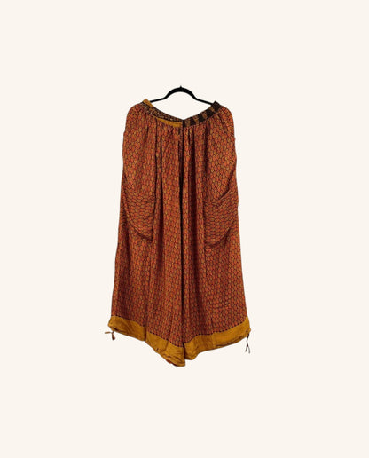 She Lives Beauty vintage rasgulla silk wide leg pants in warm orange and mustard tones with a patterned design