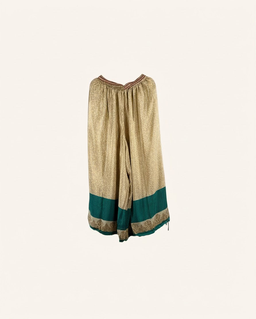 She Lives Beauty vintage rasgulla silk wide leg pants in beige with a teal green border and intricate patterns.