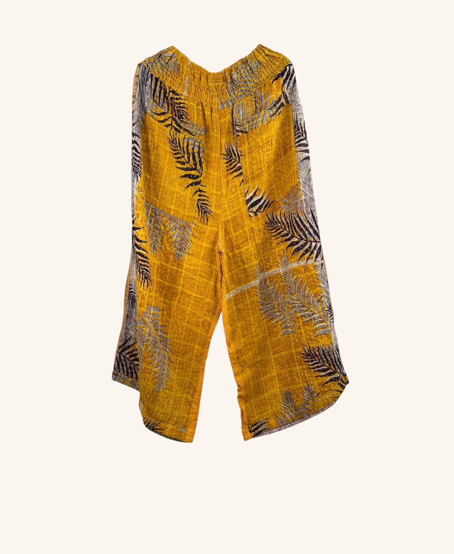 She Lives Beauty wide-leg Kantha pants in yellow vintage cotton with a black leaf print and hand-stitched details.