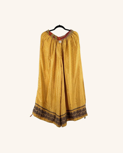 She Lives Beauty yellow vintage rasgulla silk wide leg jogger pants with intricate brown border patterns.