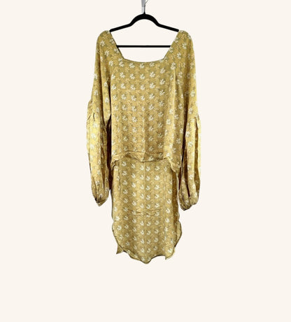She Lives Beauty Desert Rain silk top in yellow with white floral print, featuring ruffle sleeves and hi-low hem.